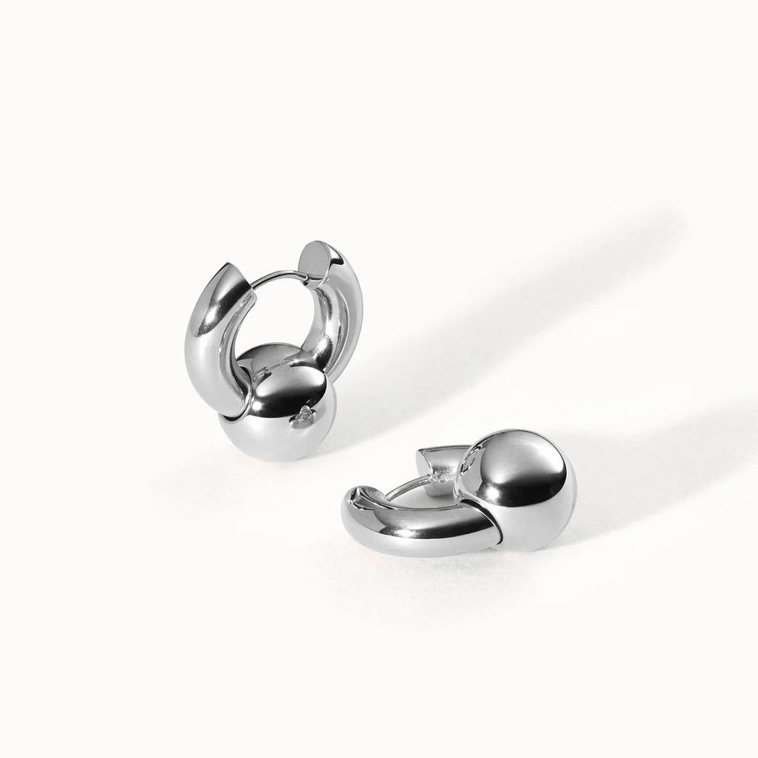 Pair of silver hoop earrings on a white background