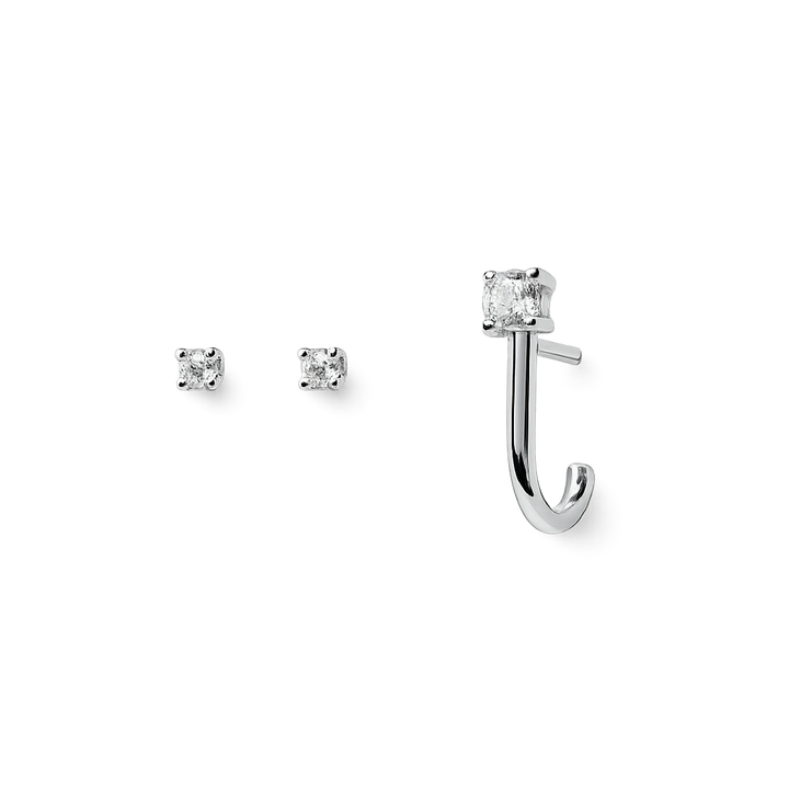 Silver earring set with clear gemstones on a white background