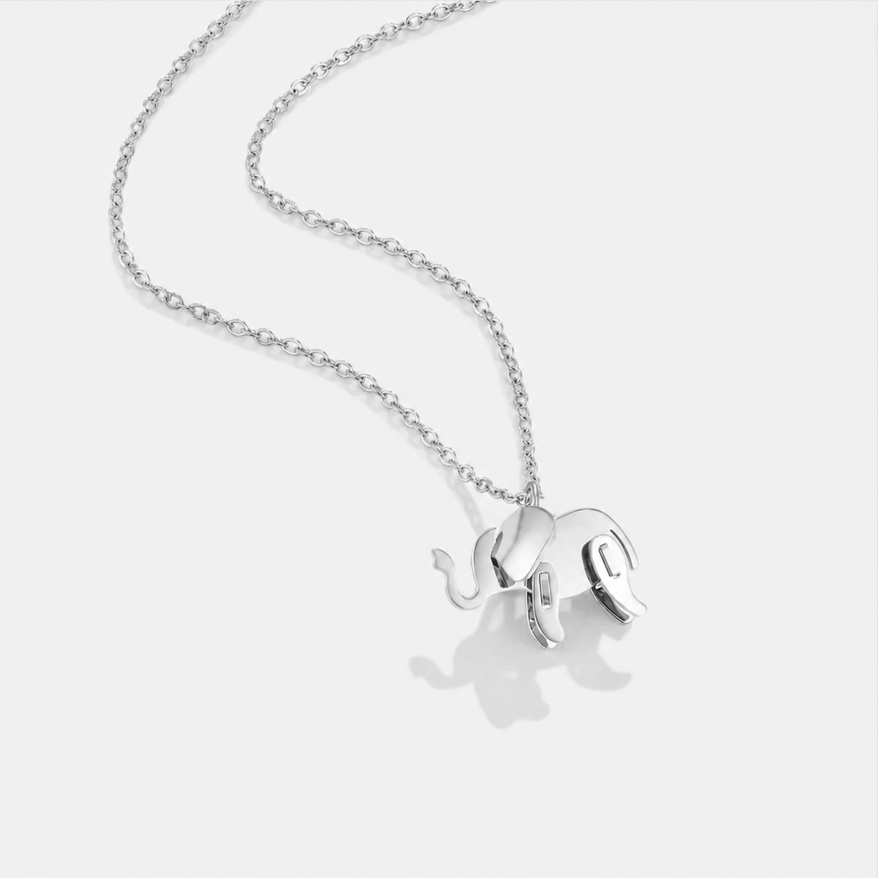 Silver elephant pendant necklace on a white background