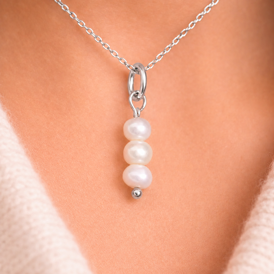 Pearl necklace with silver chain on a mannequin