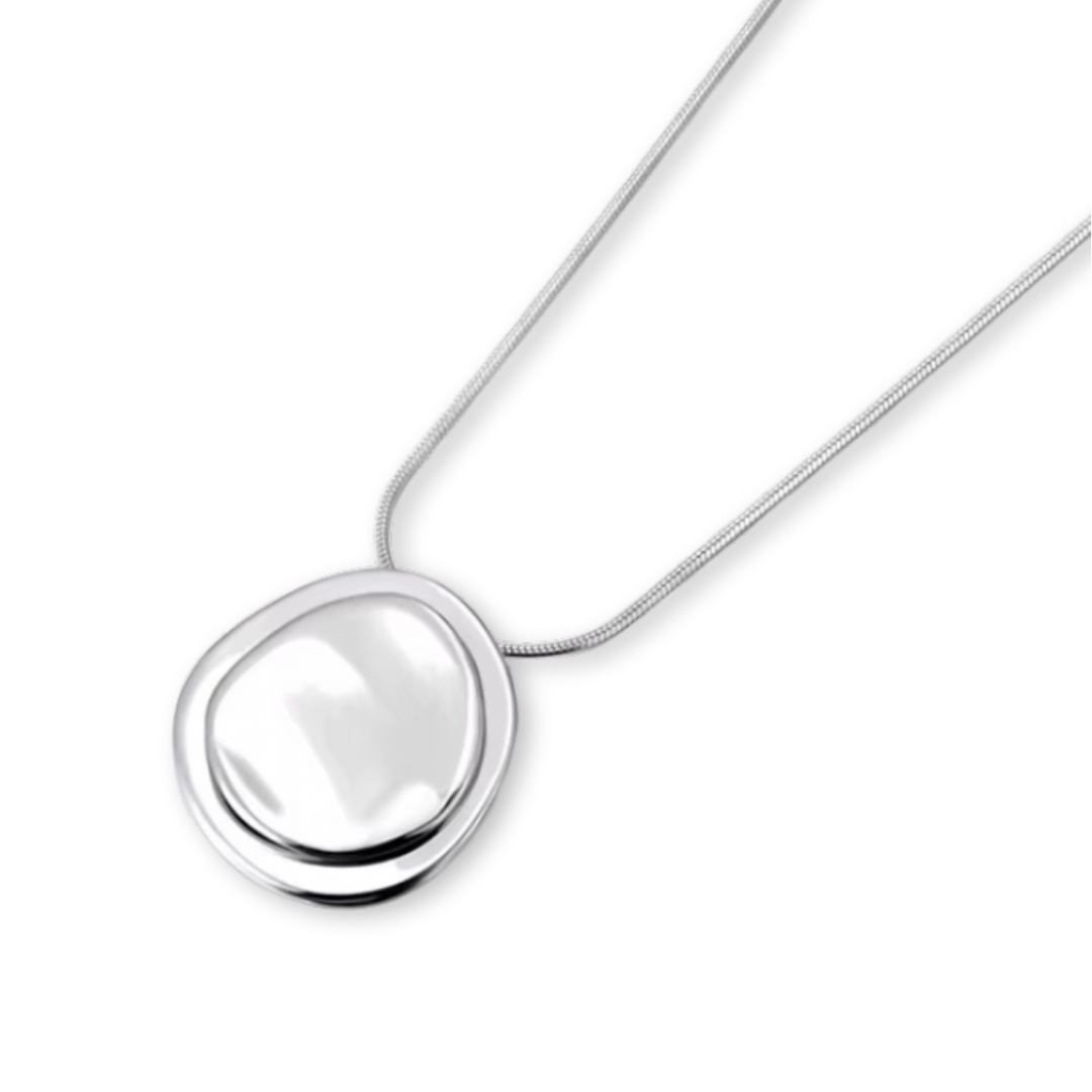 Silver necklace with a round pendant on a white background