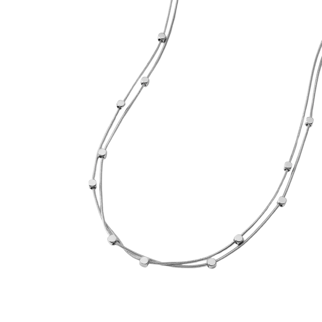 Silver necklace with small beads on a white background