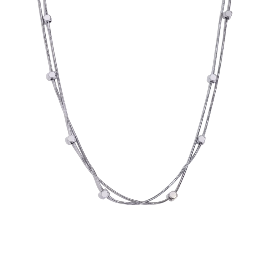 Silver necklace with small beads on a white background
