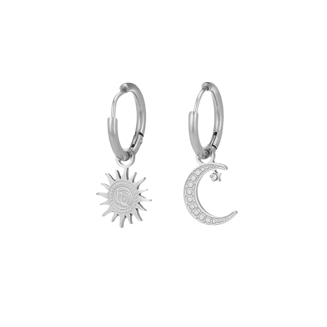 Silver hoop earrings with sun and moon charms on a white background