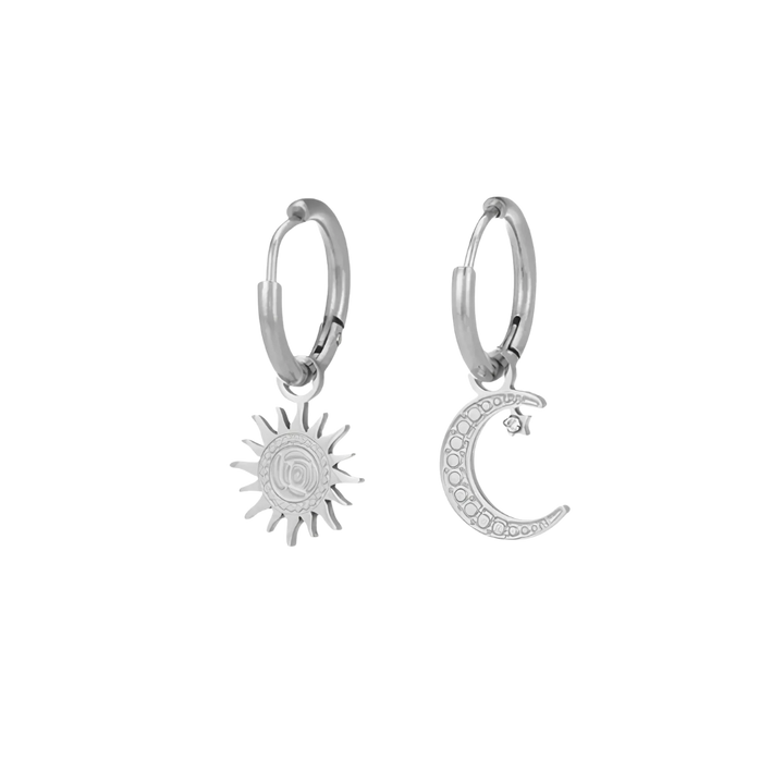 Silver hoop earrings with sun and moon charms on a white background