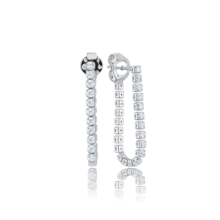 Silver earrings with clear gemstones on a white background