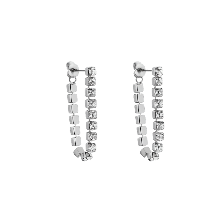 Pair of silver earrings with square beads on a white background