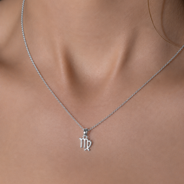 Silver Virgo zodiac necklace on a person's neck