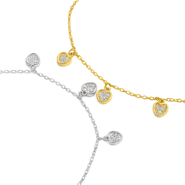Two gold and silver necklaces with heart-shaped pendants on a white background