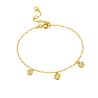 Gold bracelet with heart-shaped charms on a white background