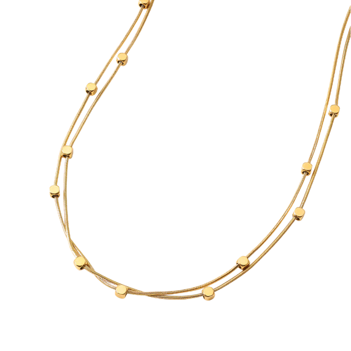 Gold necklace with small round beads on a white background