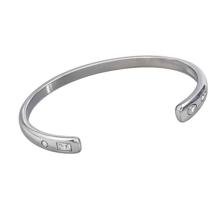 Silver bracelet with embedded stones on a white background