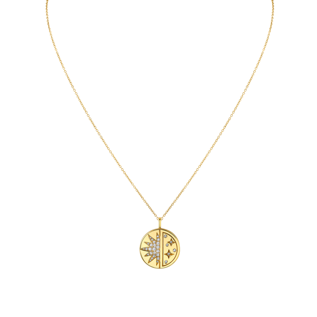Gold necklace with a circular pendant on a white background