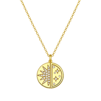 Gold necklace with a circular pendant featuring star designs on a white background