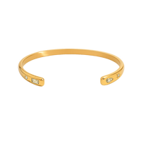 Gold bracelet with small gemstones on a white background