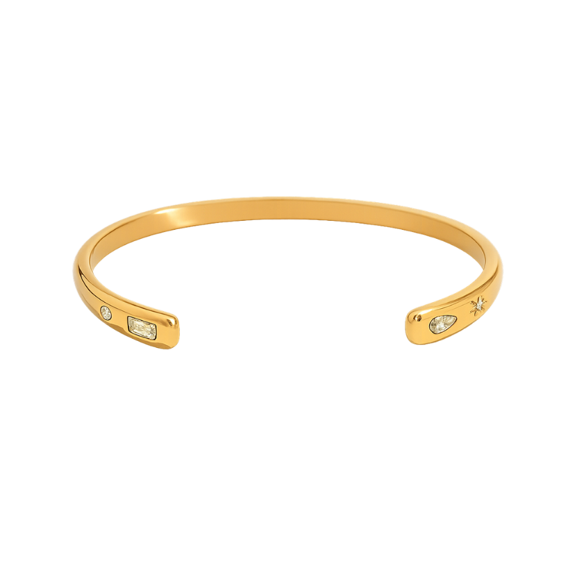 Gold bracelet with small gemstones on a white background