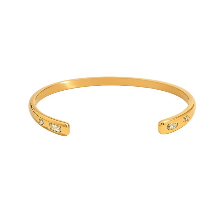 Gold bracelet with small gemstones on a white background