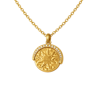 Gold necklace with a sun-shaped pendant on a white background
