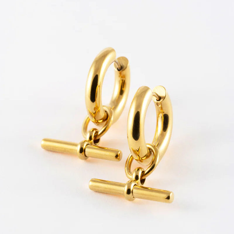 Gold hoop earrings with bar accessories on a white background
