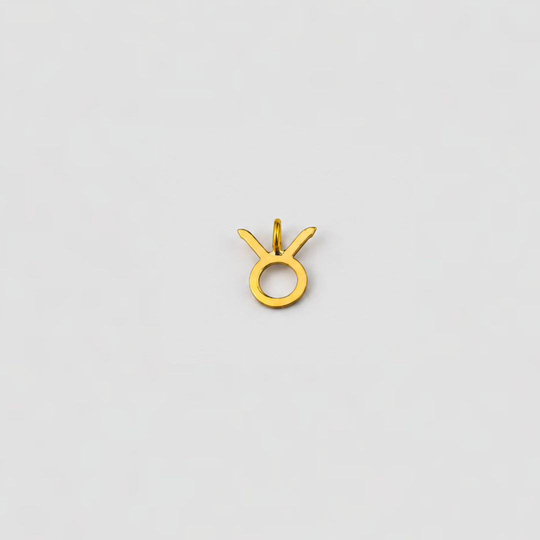 taurus ear charm on a light gray background