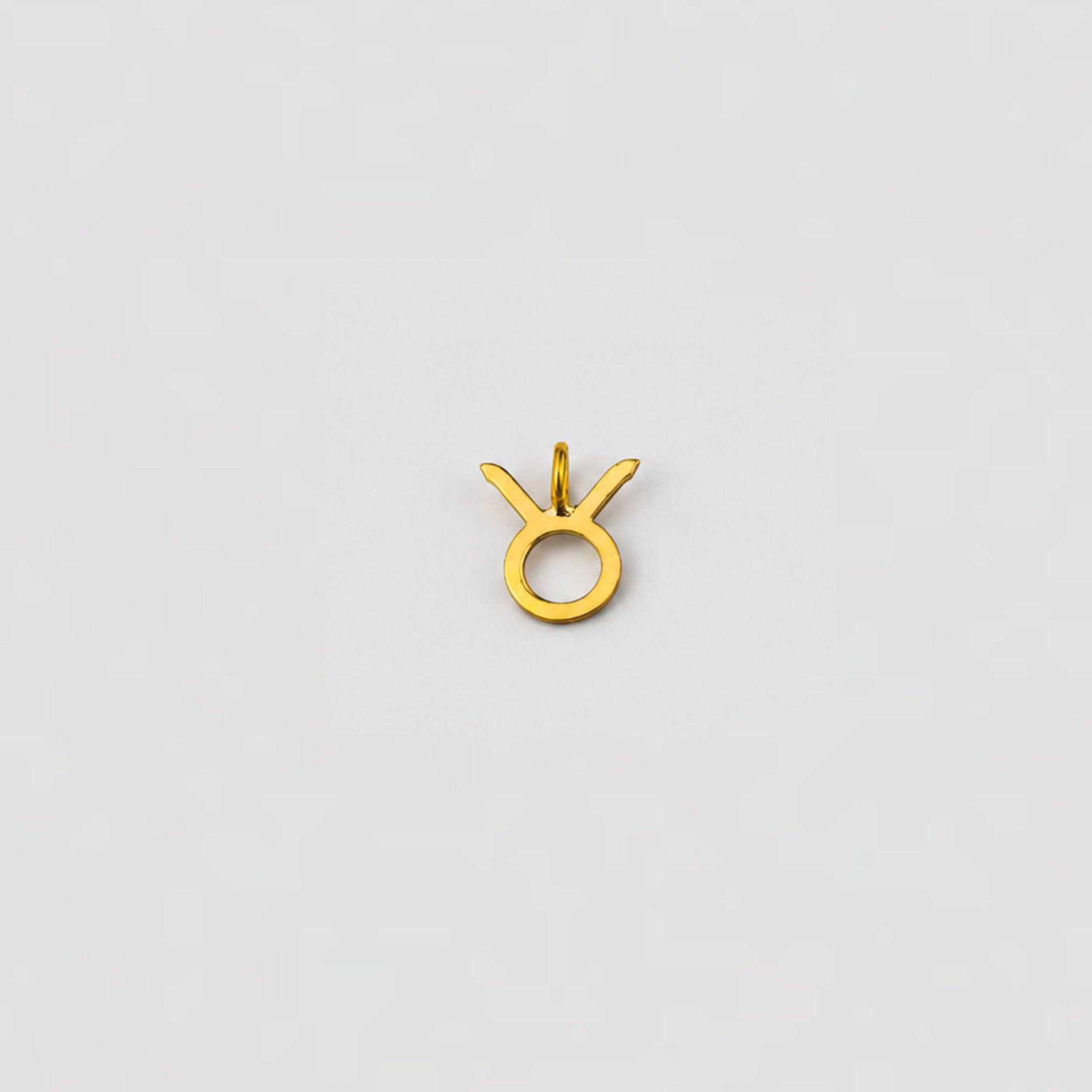 taurus ear charm on a light gray background