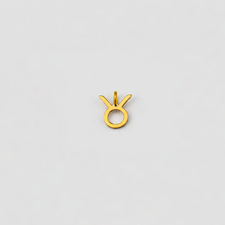 taurus ear charm on a light gray background