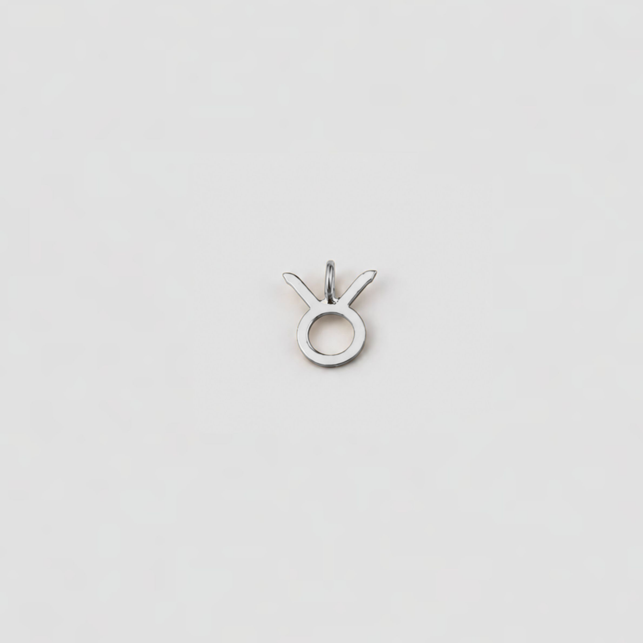 Silver pendant with a unique design on a light gray background