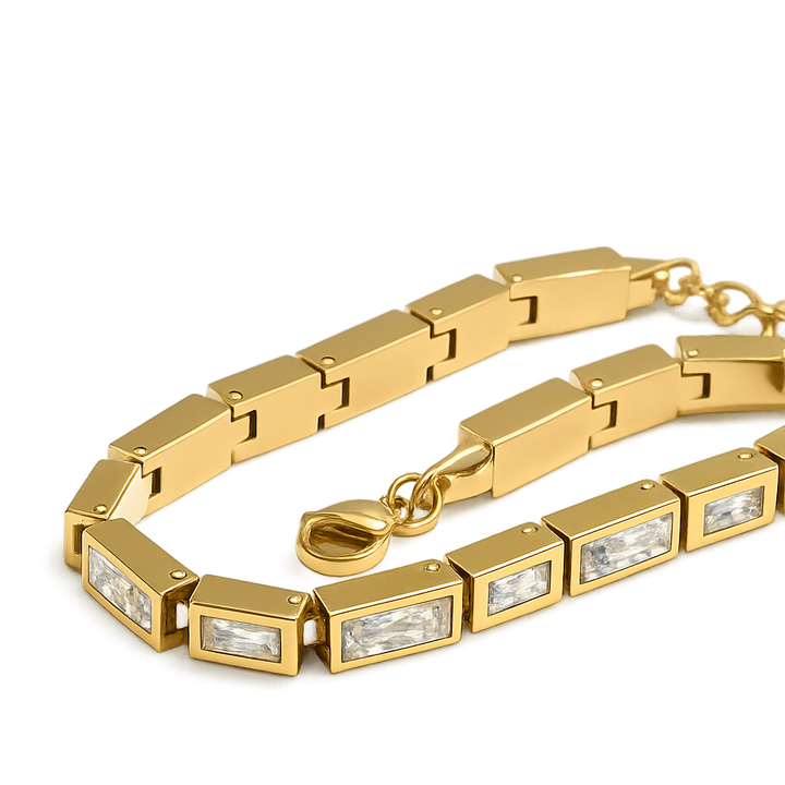 Gold bracelet with rectangular gemstones on a white background