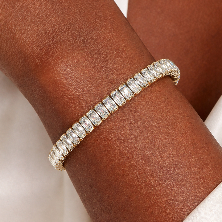 Diamond bracelet on a person's wrist with a neutral background