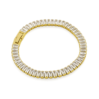 Gold bracelet with clear gemstones on a white background