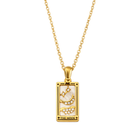 Gold necklace with a rectangular pendant featuring 'The Moon' design on a white background