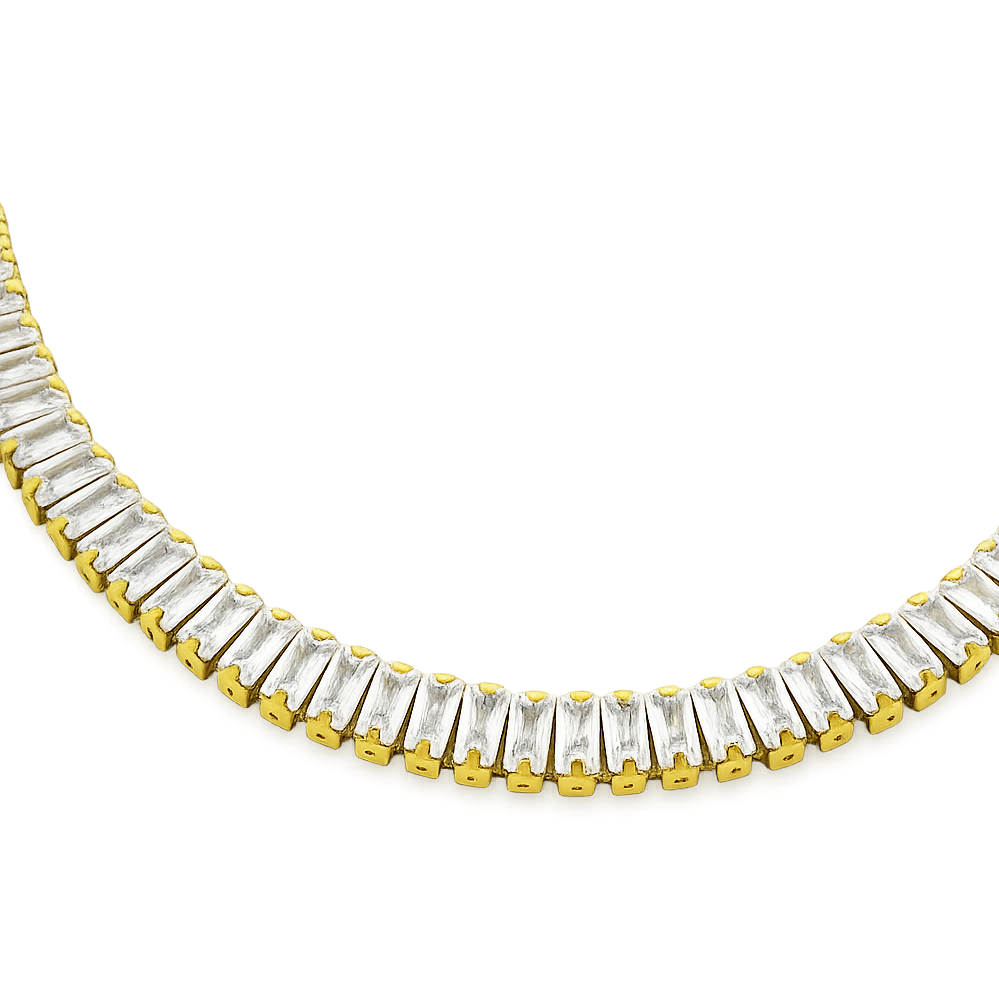 Gold and clear gemstone necklace on a white background