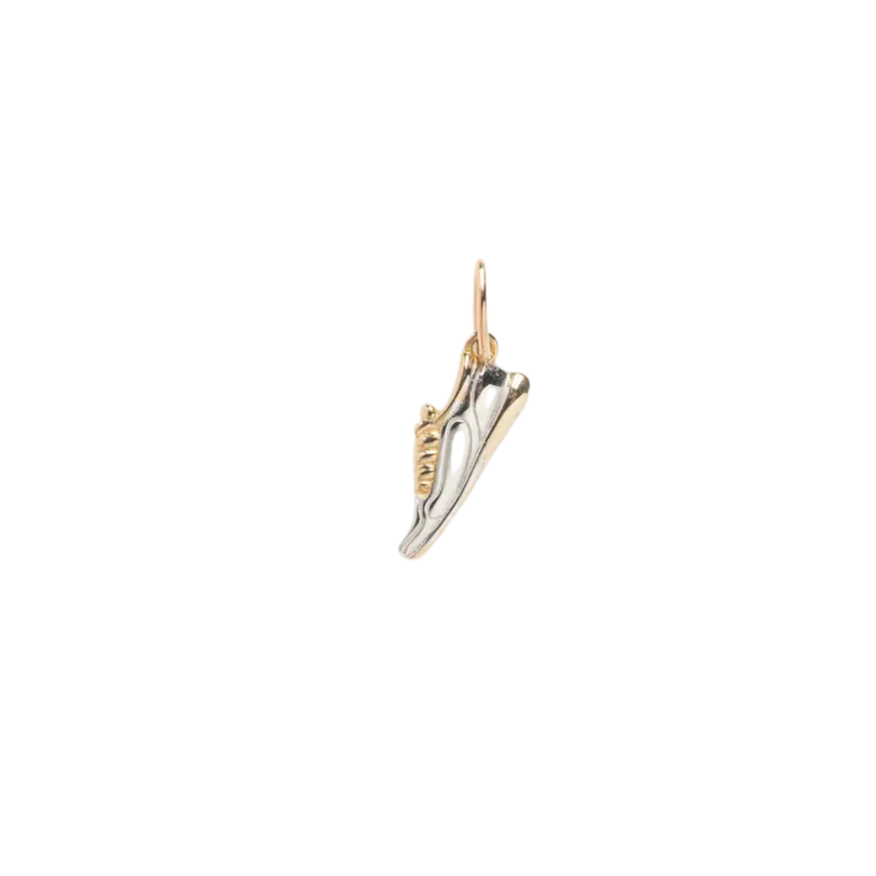 Gold and silver shoe charm on a white background