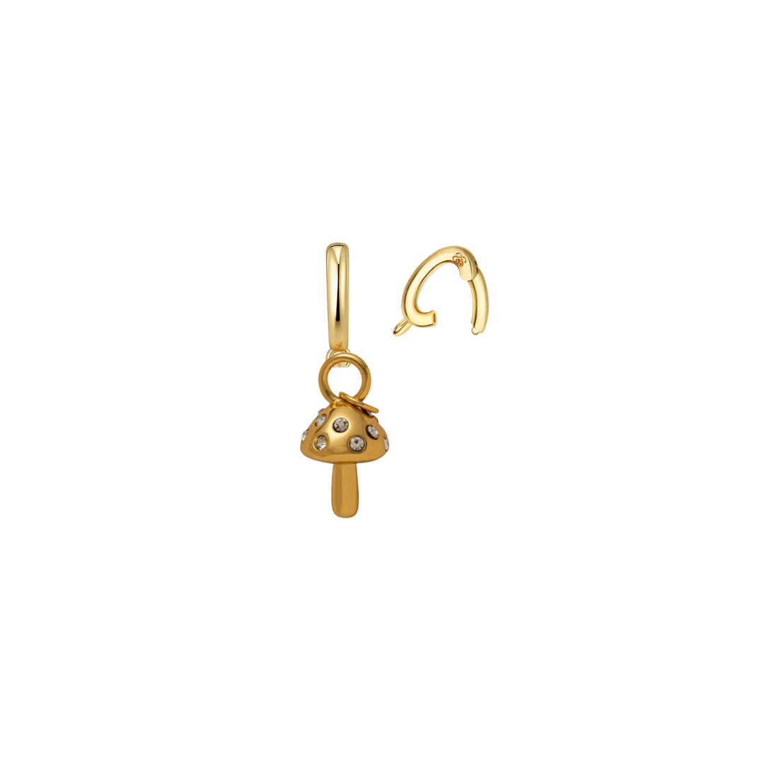 A gold mushroom-shaped stud earring with small dark and light gemstone accents, shown next to its matching curved post on a plain white background.