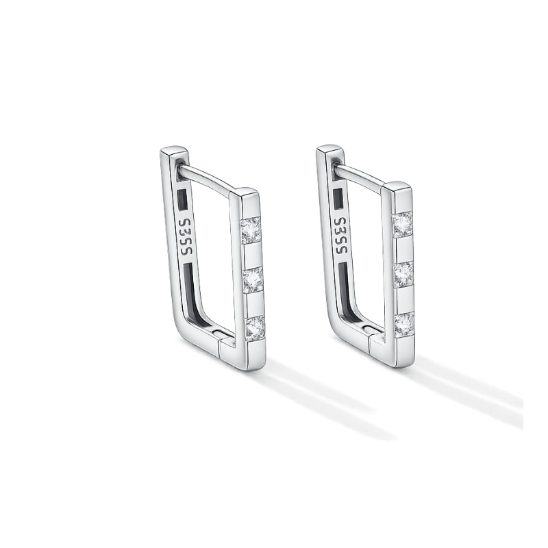 Pair of silver hoop earrings with small stones on a white background