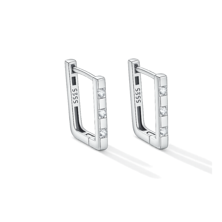 Pair of silver hoop earrings with small stones on a white background