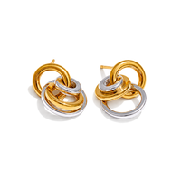 A pair of gold and silver interlocking ring stud earrings on a clean white background.