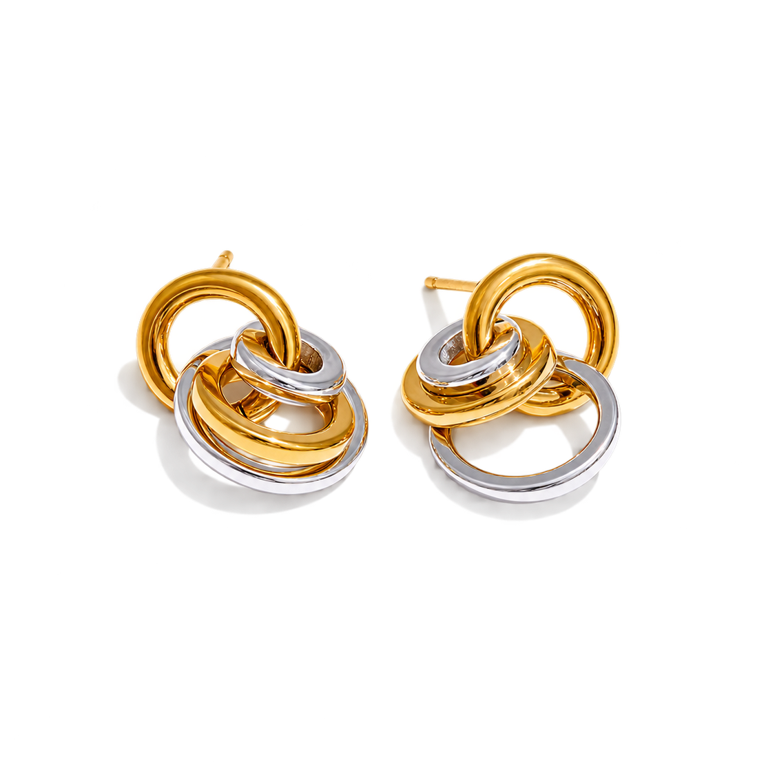 A pair of gold and silver interlocking ring stud earrings on a clean white background.