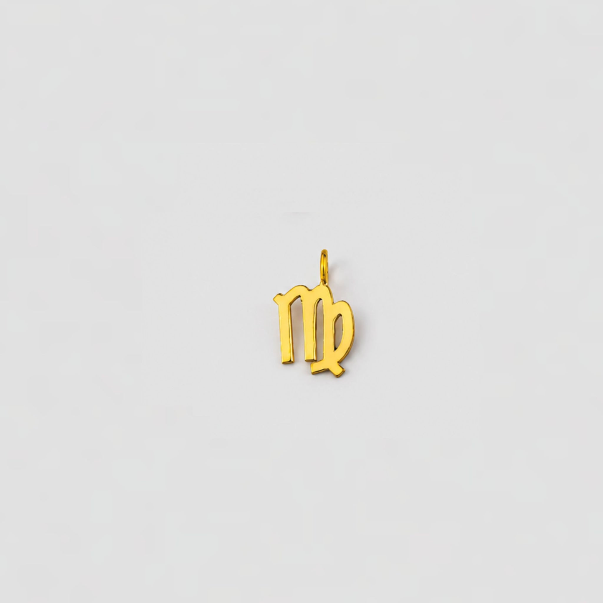 Gold Virgo zodiac pendant on a light gray background