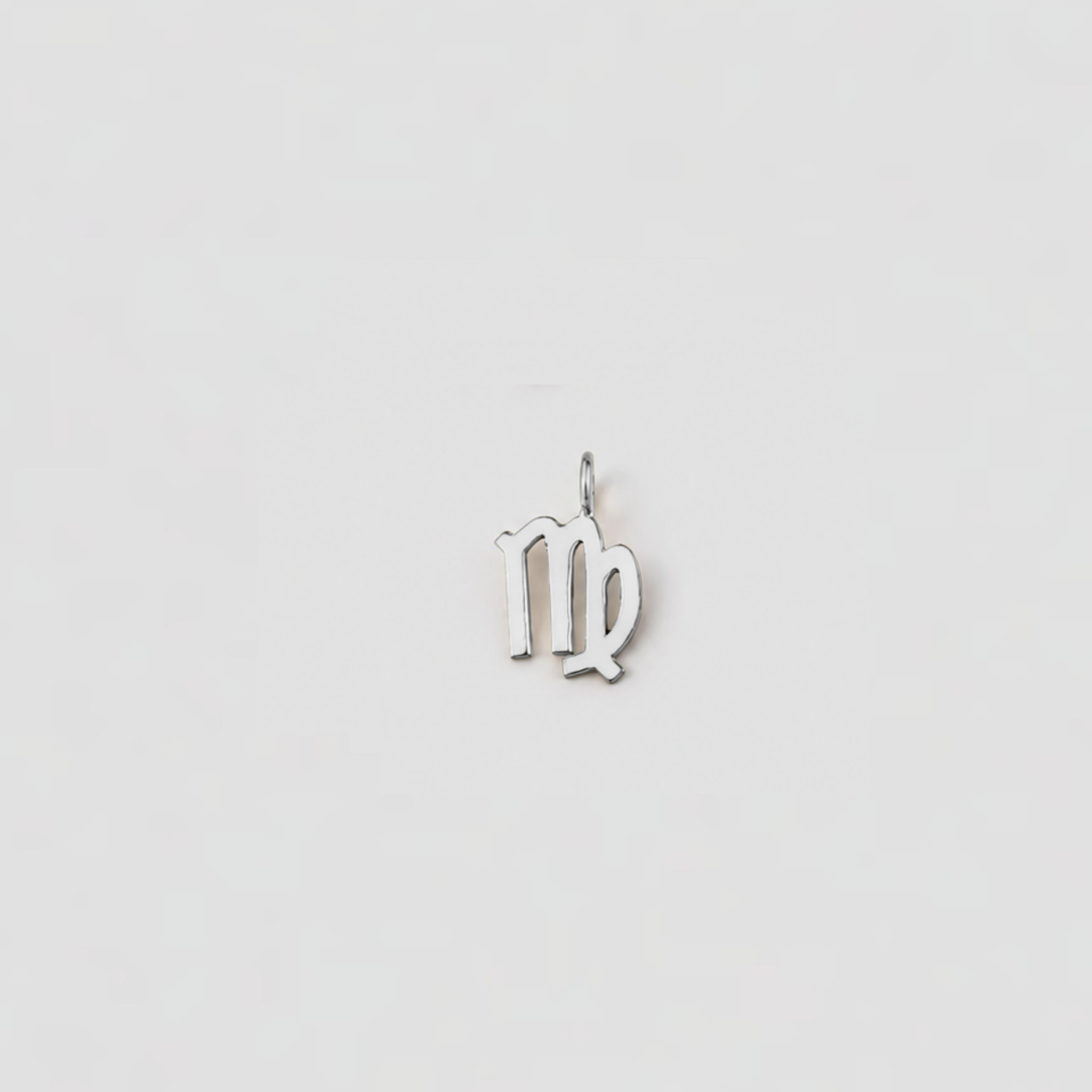 Silver Virgo zodiac pendant on a light gray background