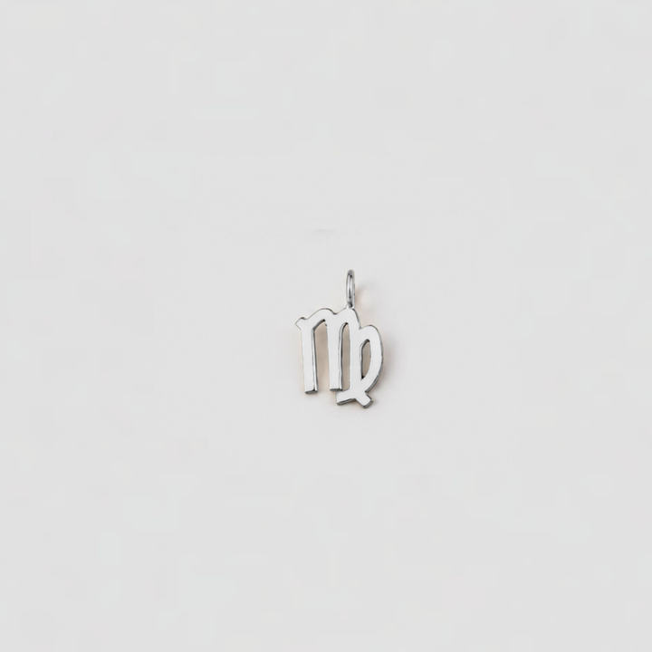 Silver Virgo zodiac pendant on a light gray background