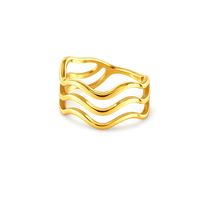 Gold ring with wavy design on a white background