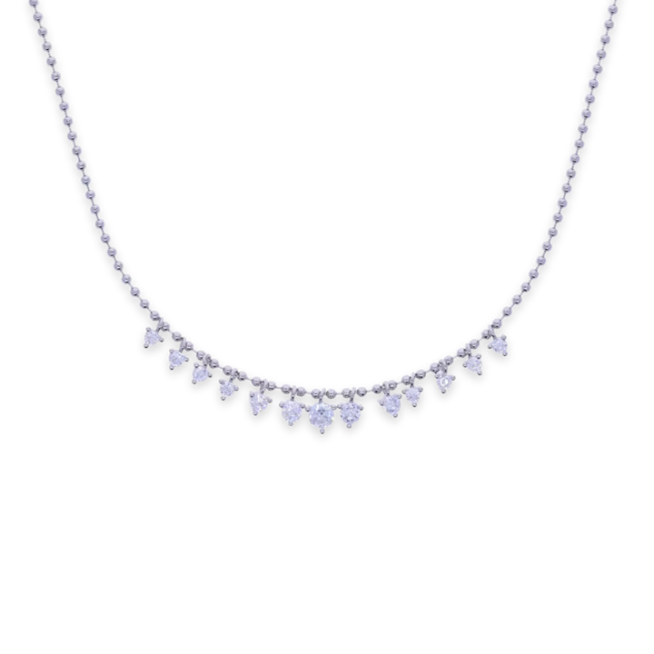 A delicate silver-toned ball chain necklace featuring a curved row of small heart-shaped clear gemstones on a plain white background.